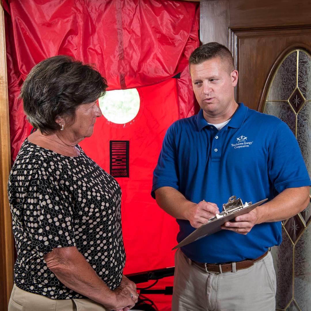 employee providing member with energy savings tips