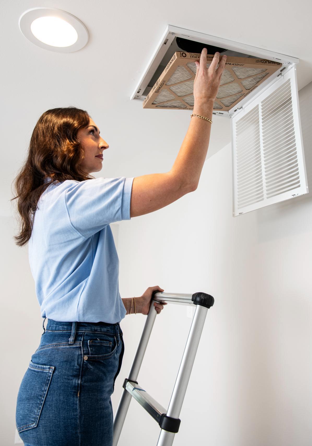 woman changing air filter